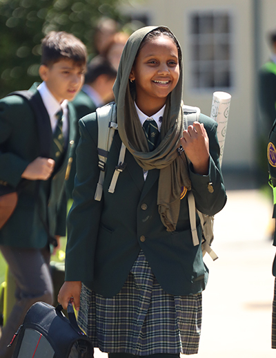 middle school - homepage Middle School girl walking with backpack.