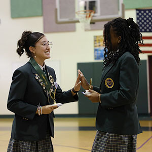 awards-girls Two girls high-five with awards