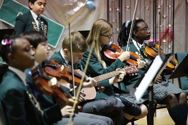 orchestra-6 students playing violin in orchestra