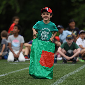 potato-sack-race Child jumping in potato sack relay race