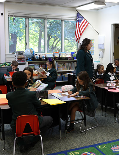 Small kindergarten students in classroom with teacher