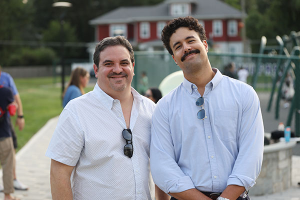 two-Westminster-dads Two men smiling at camera with sun glasses hanging from shirt