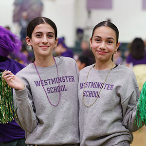 upper_school_girls_Pep_Rally Two girls in spirit wear and pom poms