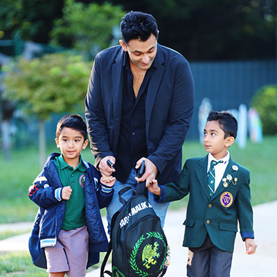 walking-with-kids Dad walking with his two sons holding hands